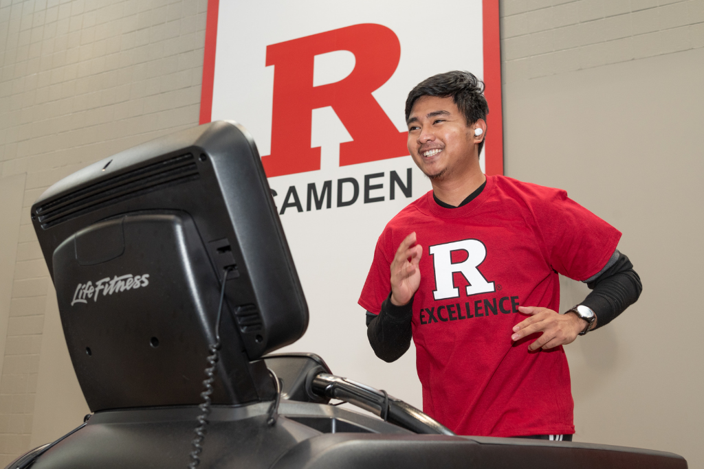 Student using gym equipment at school gym